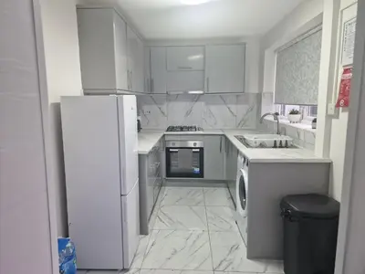 a white kitchen with a refrigerator and a dishwasher at Excellent Suite Room in Liverpool in Liverpool