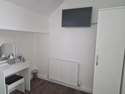 a white room with a television on the wall at Excellent Suite Room in Liverpool in Liverpool