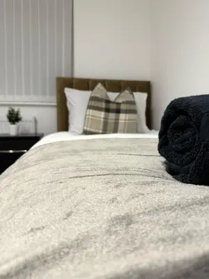a close up of a bed in a bedroom at Comfortable and Modern Living house in St Helens in Saint Helens