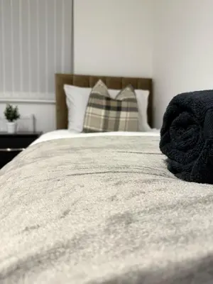 a close up of a bed in a bedroom at Comfortable and Modern Living house in St Helens in Saint Helens