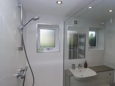 a white bathroom with a sink and a shower at Threagill in Carnforth