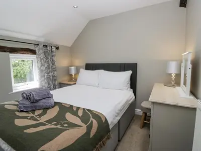 a small bedroom with a bed and a desk at Treacle in Carnforth