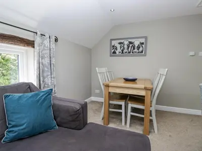 a living room with a table and a couch at Treacle in Carnforth