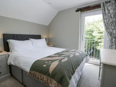 a bedroom with a large bed and a window at Treacle in Carnforth