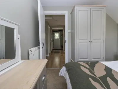 a bedroom with a bed and a mirror at Treacle in Carnforth