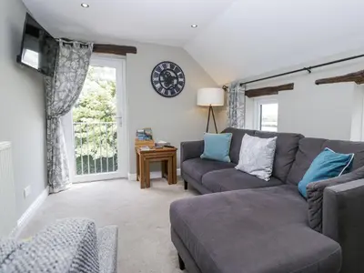 a living room with a couch and a tv at Treacle in Carnforth