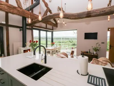 an open kitchen with a view of a living room at Lindeth Croft in Carnforth