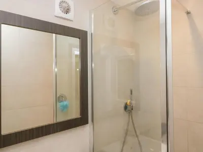 a shower with a mirror in a bathroom at Lindeth Croft in Carnforth