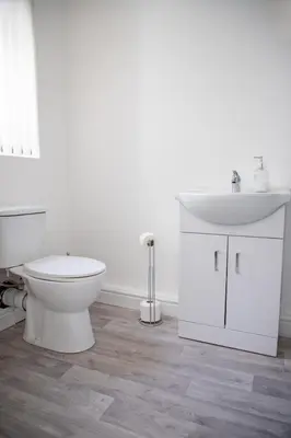 a white bathroom with a toilet and a sink at Balmoral Stays 4 - First Floor in Blackpool