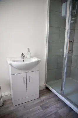 a bathroom with a sink and a shower at Balmoral Stays 4 - First Floor in Blackpool