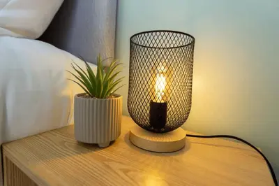 a lamp on a table with a potted plant on it at 3 Bed House 9 mins walk to Anfield Sleeps 7 in Liverpool