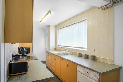 a kitchen with a sink and a counter top at Contractor Stays, Newly Renovated, Free Parking, Sleep 7 in Wallasey