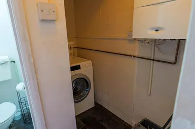 a washer and dryer in a small bathroom at Contractor Stays, Newly Renovated, Free Parking, Sleep 7 in Wallasey