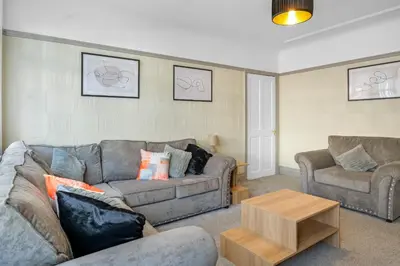 a living room with two couches and a coffee table at Contractor Stays, Newly Renovated, Free Parking, Sleep 7 in Wallasey