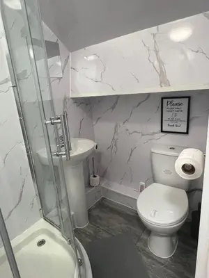 a bathroom with a shower and a toilet and a sink at Sleeps 10- Free Parking- Close To Goodison&Anfield in Liverpool