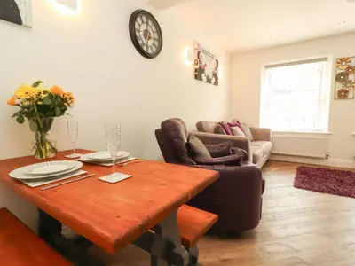 a living room with a table and a couch at Lakes View Apartment 1 in Carnforth