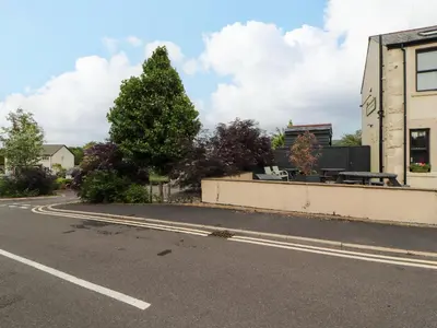 an empty road with a bench on the side of a building at Lakes View Apartment 1 in Carnforth