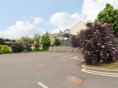 a parking lot in front of a house at Lakes View Apartment 1 in Carnforth