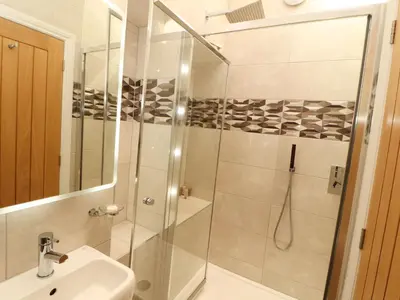 a bathroom with a shower and a sink at Lakes View Apartment 1 in Carnforth