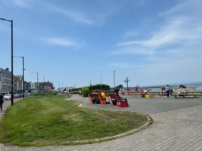 a park with benches on the side of a street at Bay Walk Place in Morecambe