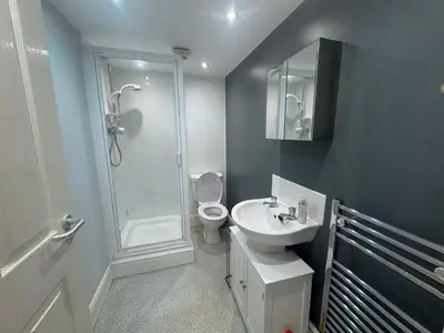 a bathroom with a shower toilet and a sink at Bay Walk Place in Morecambe