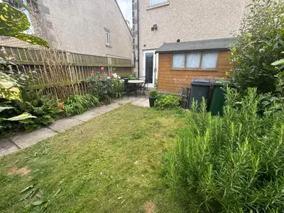 a backyard with a fence and a table and chairs at Bay Walk Place in Morecambe