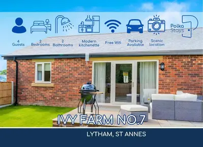 a man is standing in front of a house at No 7 PolkaStays Ivy Farm Fern Cottage in Plumpton