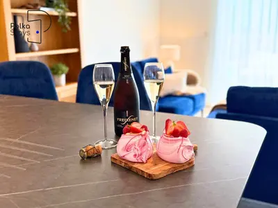 a table with two wine glasses and a bottle of wine at No 7 PolkaStays Ivy Farm Fern Cottage in Plumpton