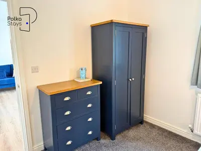 a blue cabinet and a dresser in a room at No 7 PolkaStays Ivy Farm Fern Cottage in Plumpton