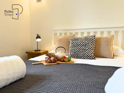 a tray of fruit sitting on top of a bed at No 7 PolkaStays Ivy Farm Fern Cottage in Plumpton