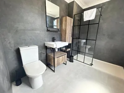 a bathroom with a white toilet and a sink at Stanley House - Luxury 6 Bed, Free Parking in Blackpool