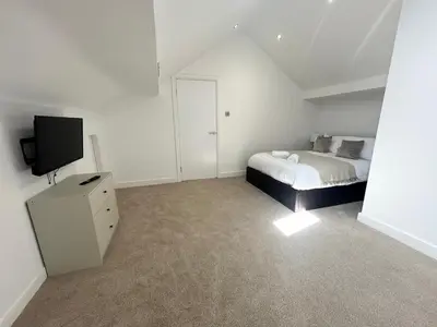 a bedroom with a bed and a tv in it at Stanley House - Luxury 6 Bed, Free Parking in Blackpool
