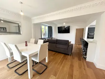 a living room with a table and chairs and a couch at Stanley House - Luxury 6 Bed, Free Parking in Blackpool