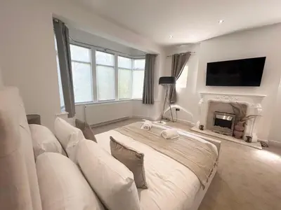 a living room with a white couch and a fireplace at Stanley House - Luxury 6 Bed, Free Parking in Blackpool