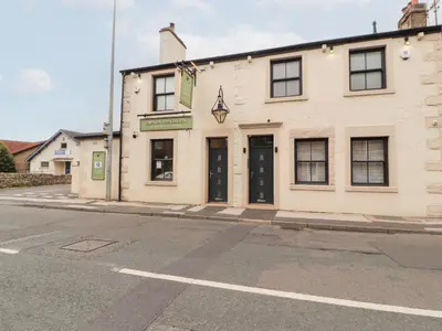 a building on the corner of a street at Lakes View Apartment 2 in Carnforth