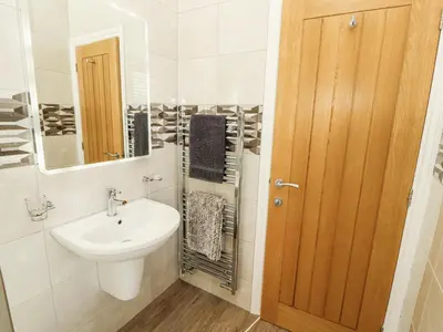 a bathroom with a sink and a mirror at Lakes View Apartment 2 in Carnforth