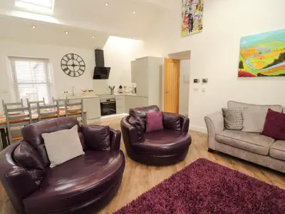 a living room with two chairs and a couch at Lakes View Apartment 3 in Carnforth