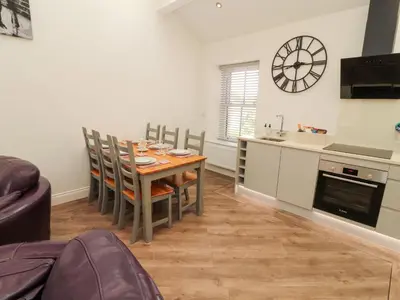 a kitchen with a table and chairs in a room at Lakes View Apartment 3 in Carnforth