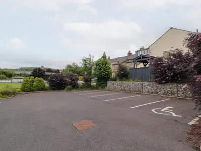 a parking lot in front of a house at Lakes View Apartment 3 in Carnforth