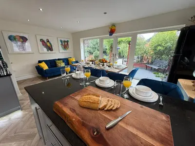 a kitchen with a table with a loaf of bread on it at The Hydeaway, Lytham St.Annes House | Free Parking in Lytham St Annes