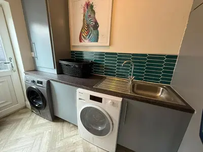 a kitchen with a washing machine and a sink at The Hydeaway, Lytham St.Annes House | Free Parking in Lytham St Annes