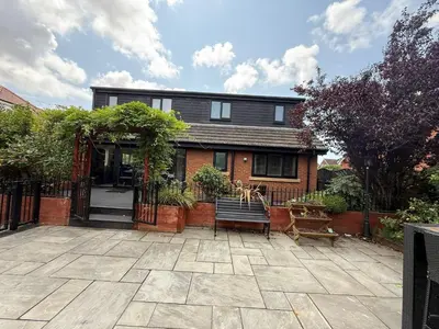 a house with a gate and a bench in front of it at The Hydeaway, Lytham St.Annes House | Free Parking in Lytham St Annes