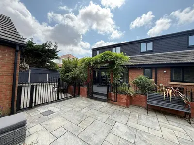 a house with a gate and a bench in front of it at The Hydeaway, Lytham St.Annes House | Free Parking in Lytham St Annes