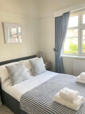 a bedroom with a bed with two towels on it at Palm House Lytham St Annes in Lytham St Annes