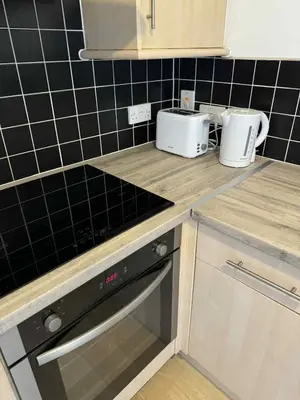 a kitchen with a counter top with a stove top oven at City Centre Apartment in Liverpool
