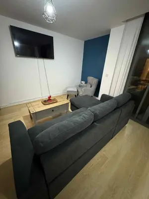 a living room with a couch and a tv at City Centre Apartment in Liverpool