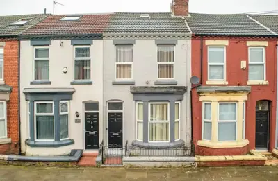 a row of houses with black doors at The Red Retreat, 7 Beds, Garden, Free Parking, Contractors, Fast Wifi, Smart TV in Liverpool