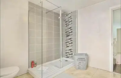 a shower with a glass door in a bathroom at The Red Retreat, 7 Beds, Garden, Free Parking, Contractors, Fast Wifi, Smart TV in Liverpool