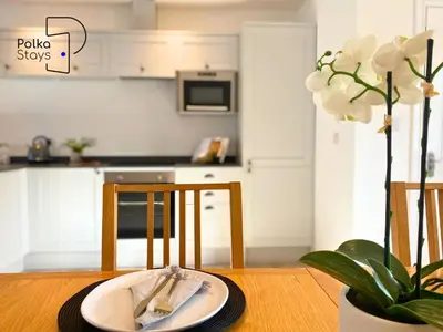 a dining room table with a plate and a plant at No 6 PolkaStays Ivy Farm Orchard Suite in Plumpton