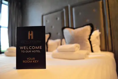 a welcome to our hotel sign sitting on top of a bed at The Eccleston Hotel; BW Signature Collection in Saint Helens